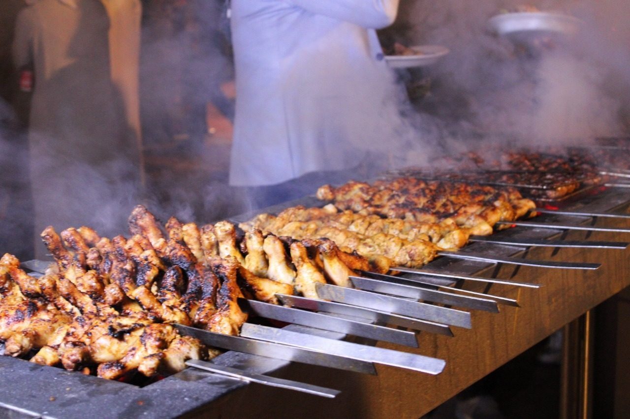 Skewers being grilled at a desert safari camp
